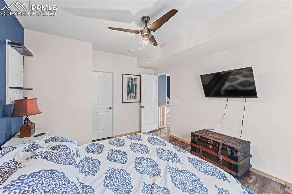 Image 42 of 48: Basement Bedroom featuring wood finished floors and ceiling fan