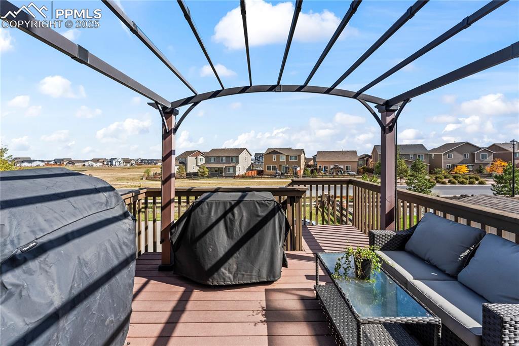 Image 43 of 48: Wooden deck with a residential view, an outdoor hangout area, and area for 