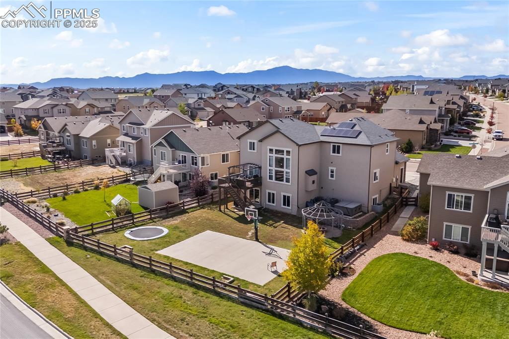 Image 47 of 48: Aerial view of residential backyard featuring a mountainous background