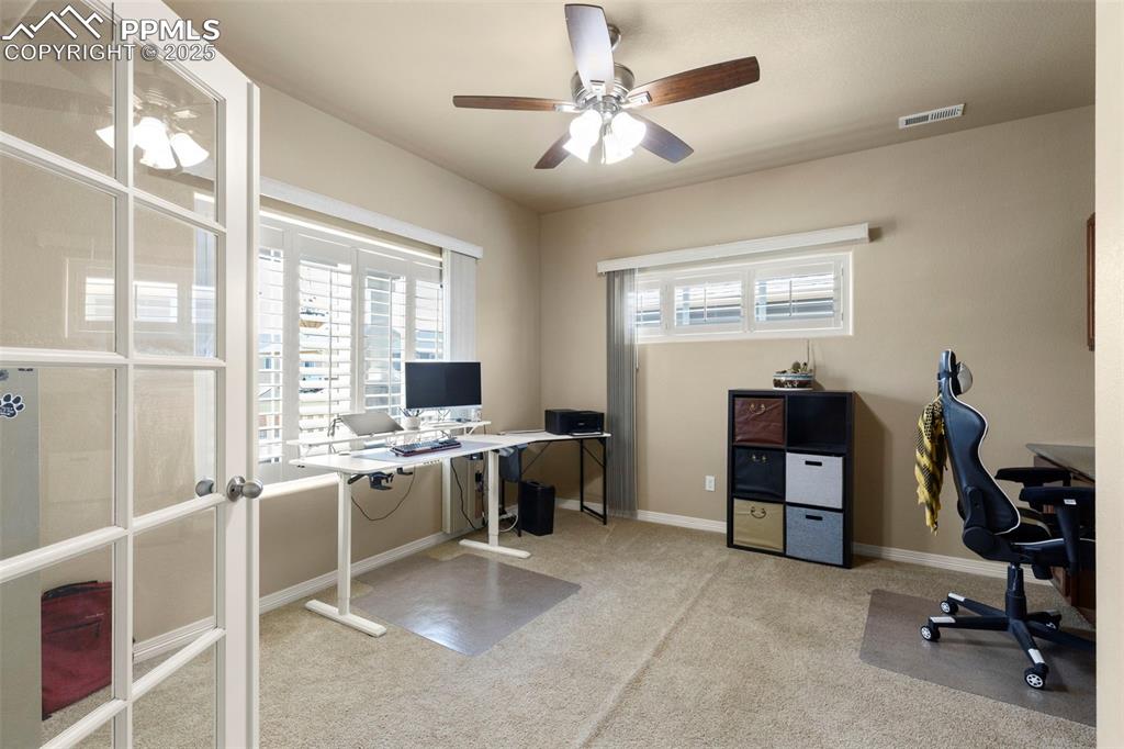 Image 7 of 27: Office with ceiling fan and carpet