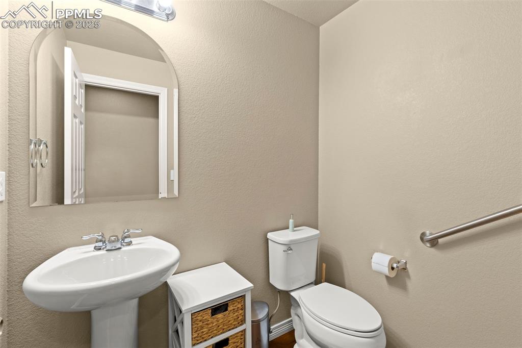 Image 8 of 27: Half bathroom with toilet and a sink