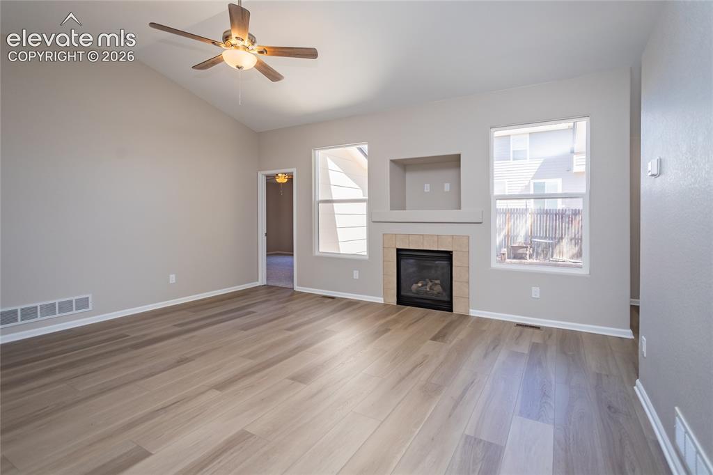 Image 12 of 39: Large windows to let in the light & a gas fireplace for ambiance & cozy Col