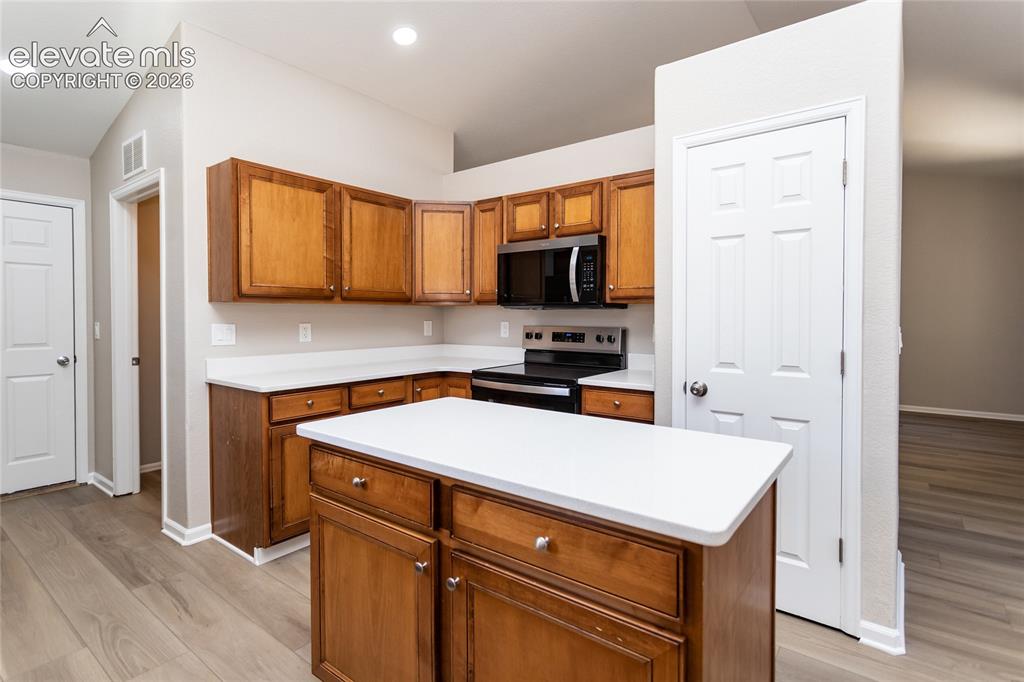 Image 21 of 39: Roomy kitchen island & large pantry - perfect for every cook!