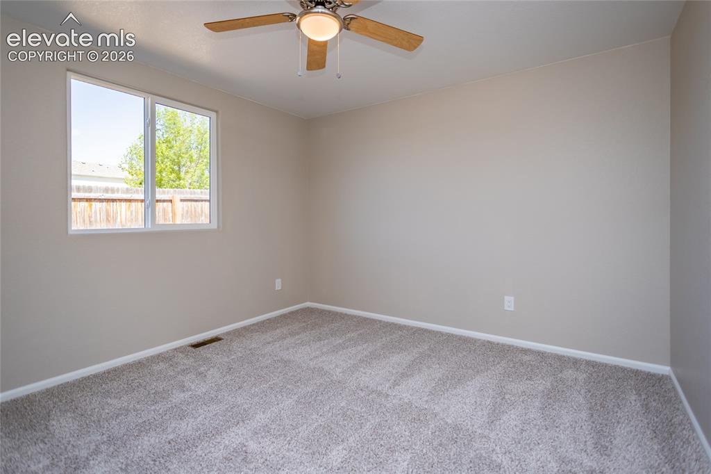 Image 26 of 39: Fresh paint, new carpet, lighted ceiling fan - nice secondary bedroom!