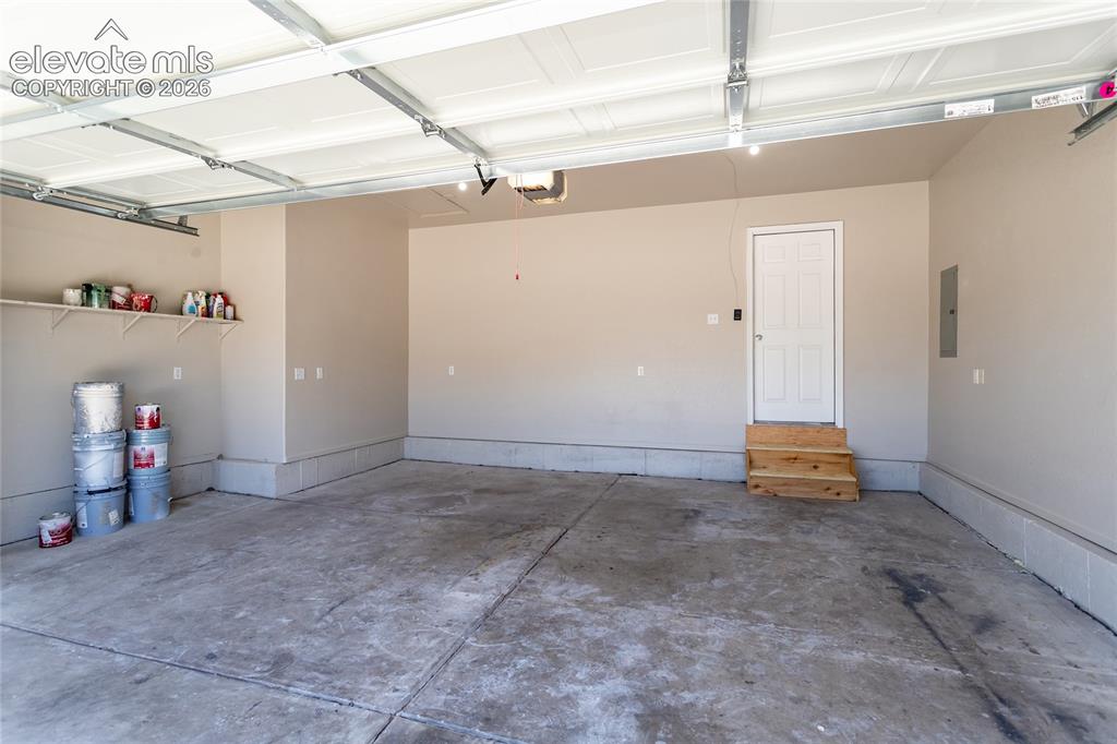 Image 38 of 39: Finished garage, plenty of outlets, room for your vehicles, shop, storage &
