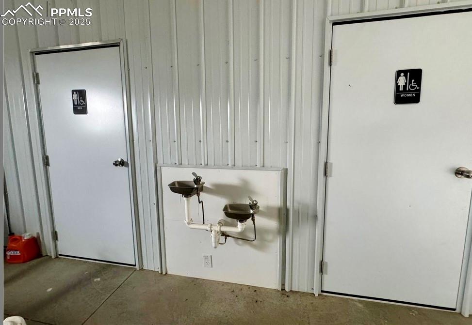 Image 4 of 5: Detailed view of concrete floors and wooden walls