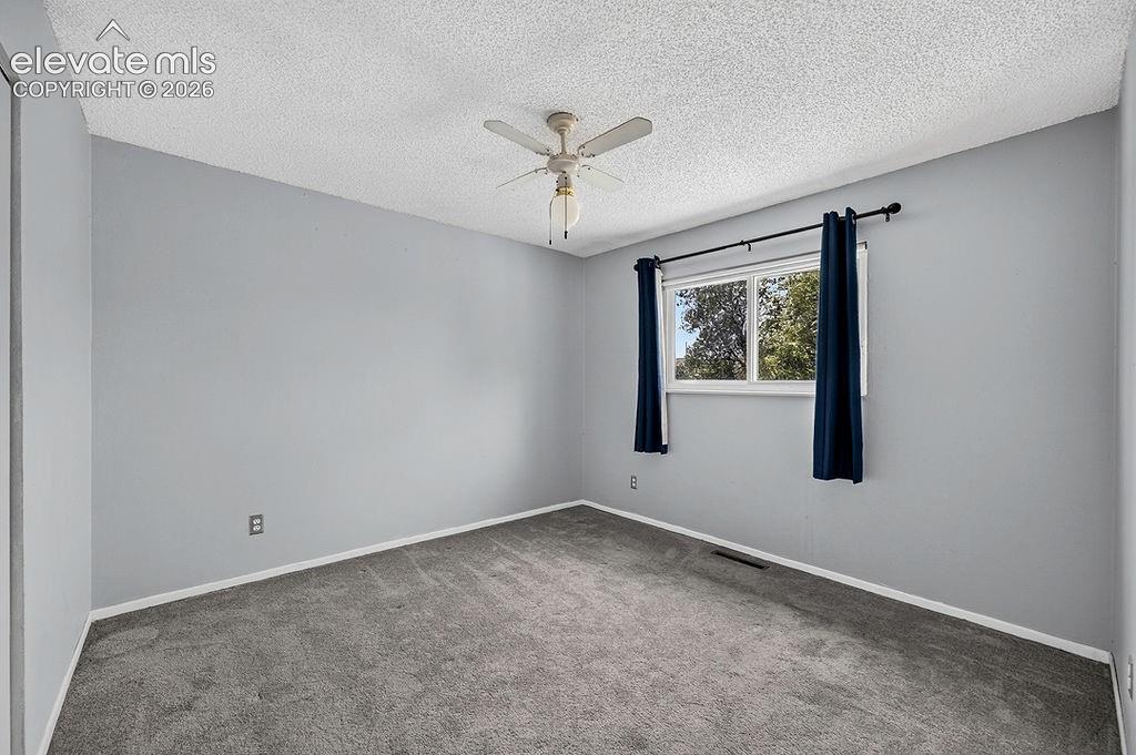 Image 32 of 44: Carpeted room featuring light gray walls and white trim