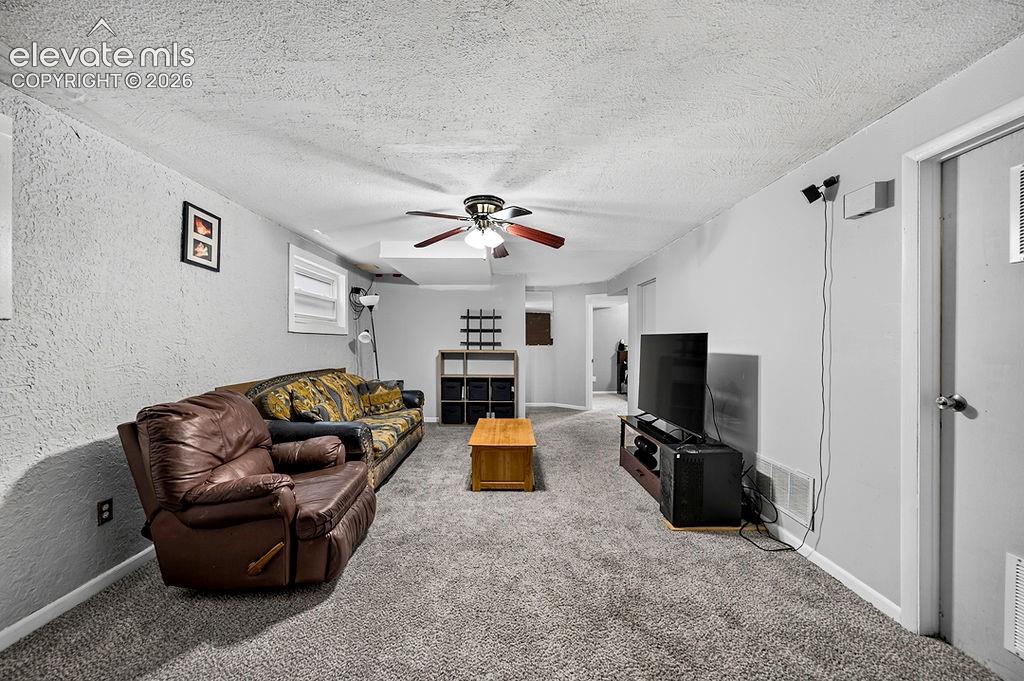 Image 38 of 44: Carpeted room featuring light gray walls and a ceiling fan with integrated 