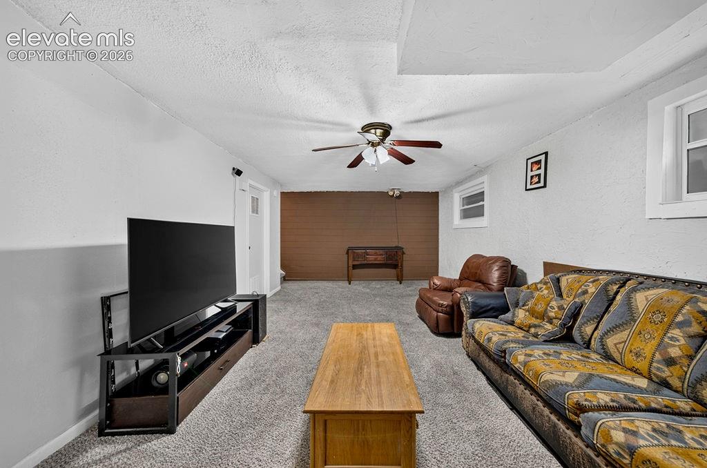 Image 39 of 44: Carpeted interior space featuring a ceiling fan with integrated lighting, m