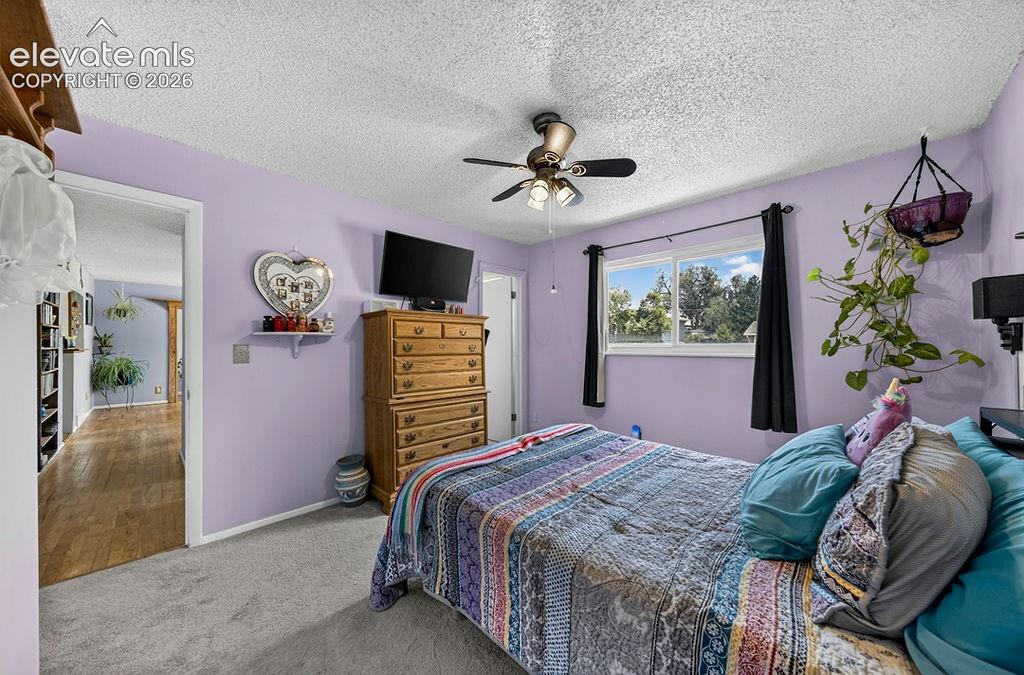 Image 41 of 44: Wall-to-wall carpeting and a ceiling fan with integrated lighting