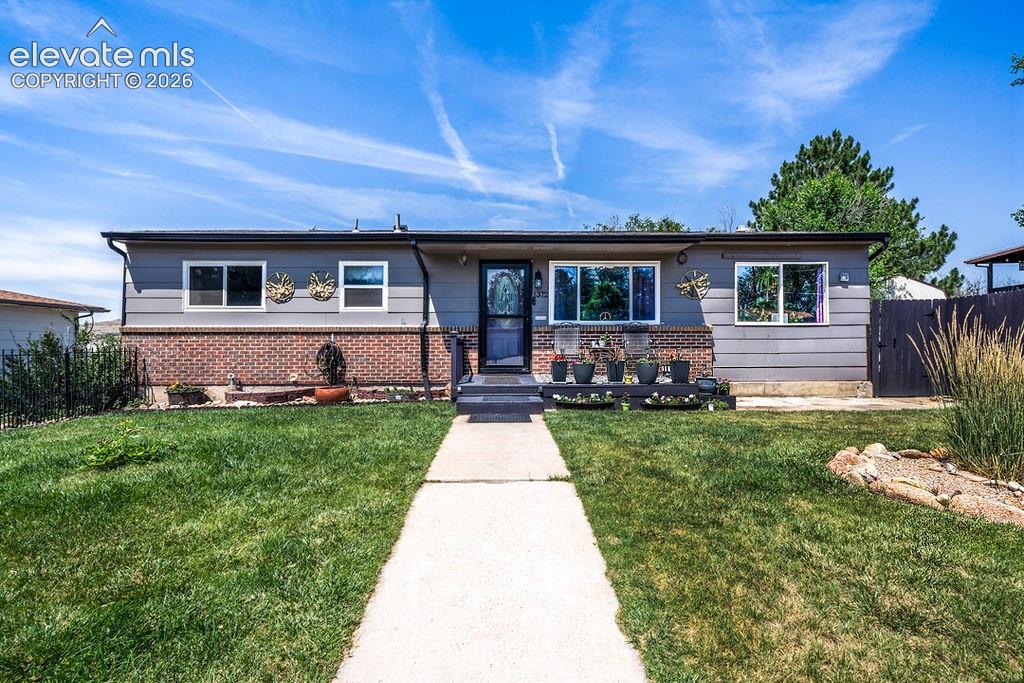 Image 43 of 44: Ranch-style residence featuring a gray exterior with brick accents