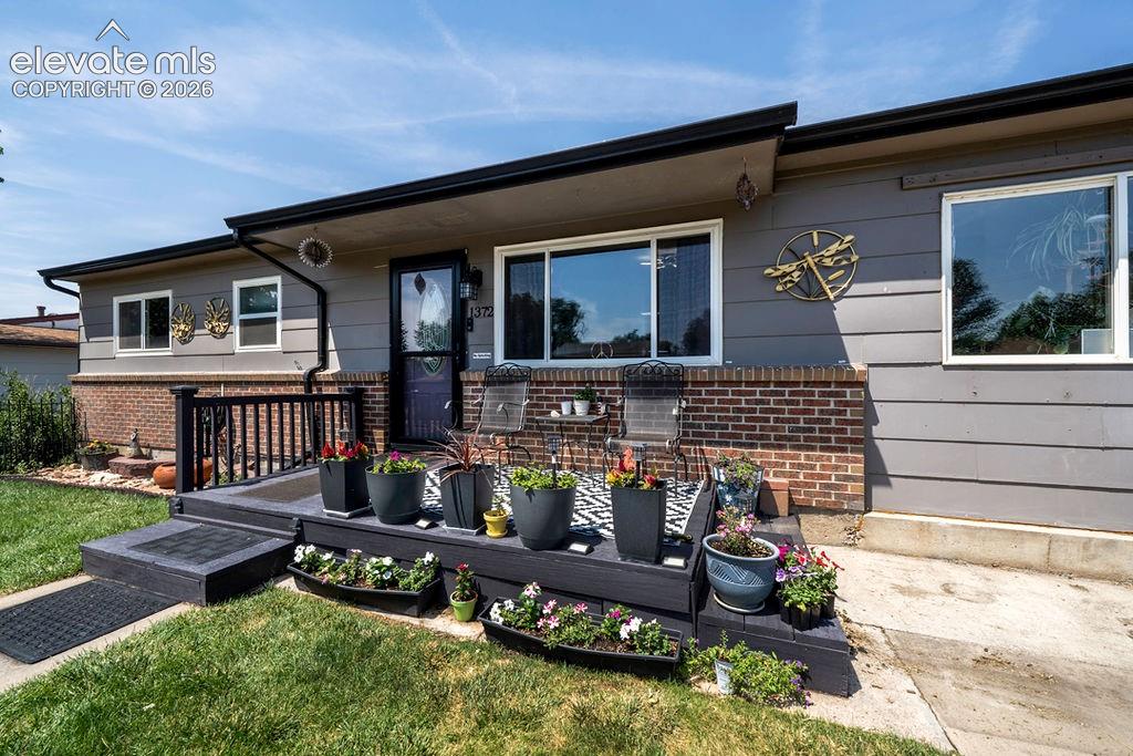 Image 44 of 44: Ranch-style residence featuring horizontal siding and a brick facade