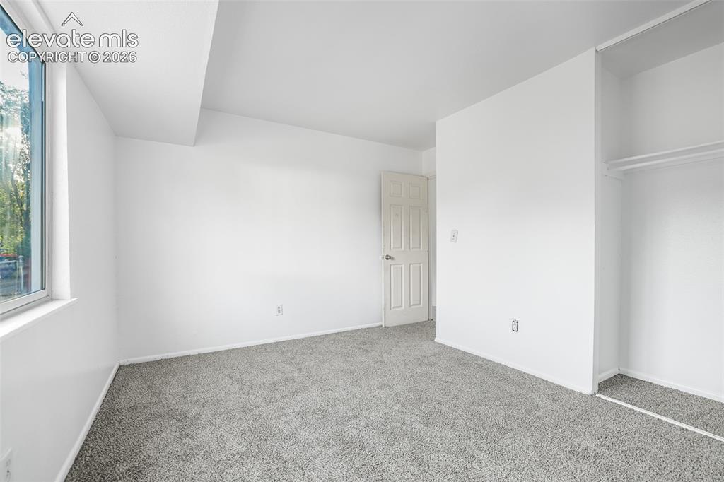 Image 10 of 19: Spacious bedroom featuring neutral wall finishes, carpeted flooring, abunda