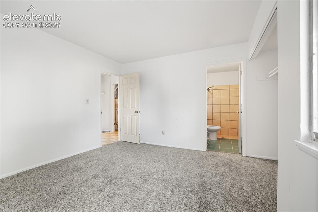 Image 14 of 19: Spacious bedroom featuring neutral wall finishes, neutral carpet flooring, 