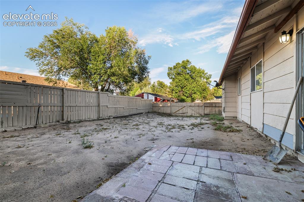 Image 18 of 19: Spacious backyard offering multiple zones for outdoor living and entertainm
