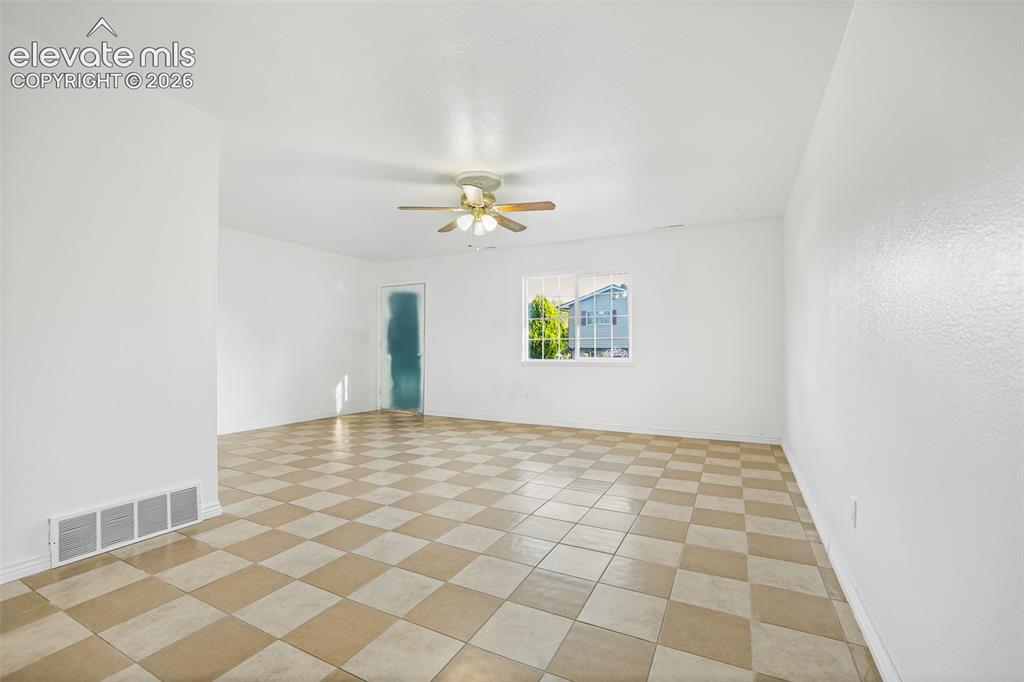 Image 4 of 19: Spacious open room featuring a geometric tile floor in warm tan and cream t