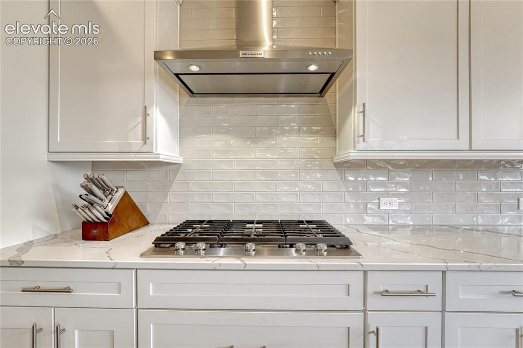 Image 13 of 41: ...gas cooktop, stylish vent hood...