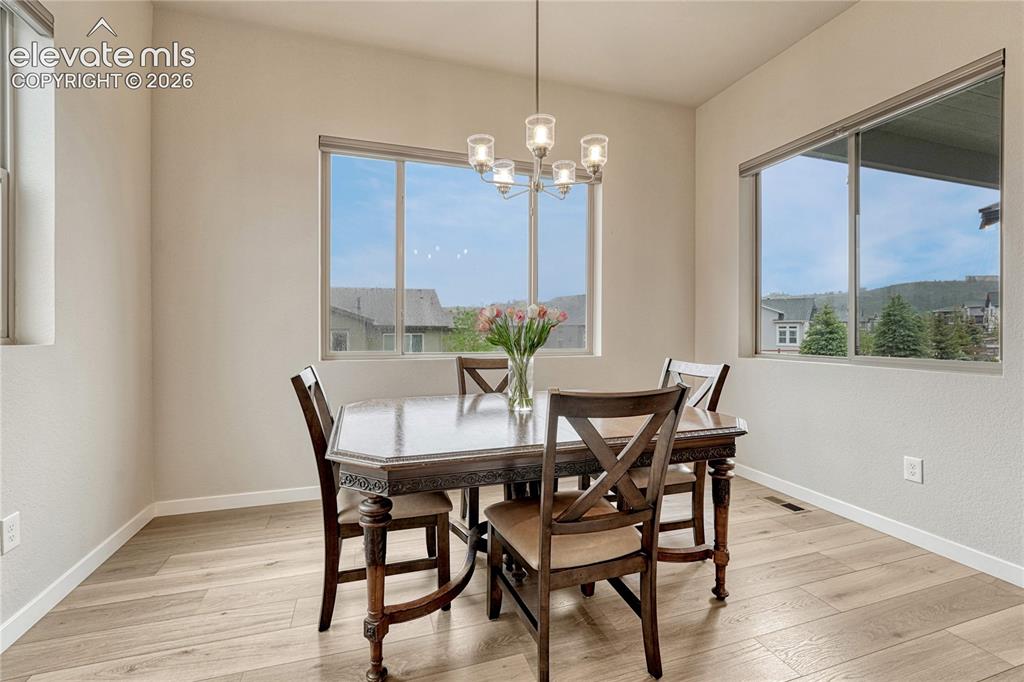 Image 15 of 41: Dining area with abundant natural light and backyard views. 