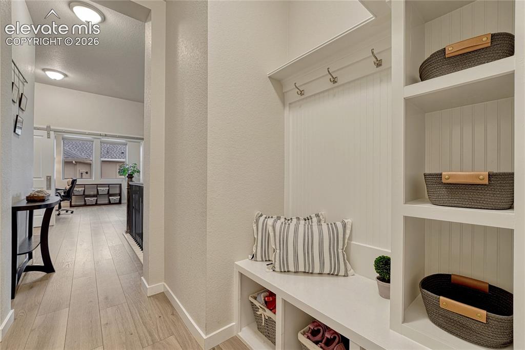 Image 23 of 41: Convenient space for catch-alls in this mud room. 