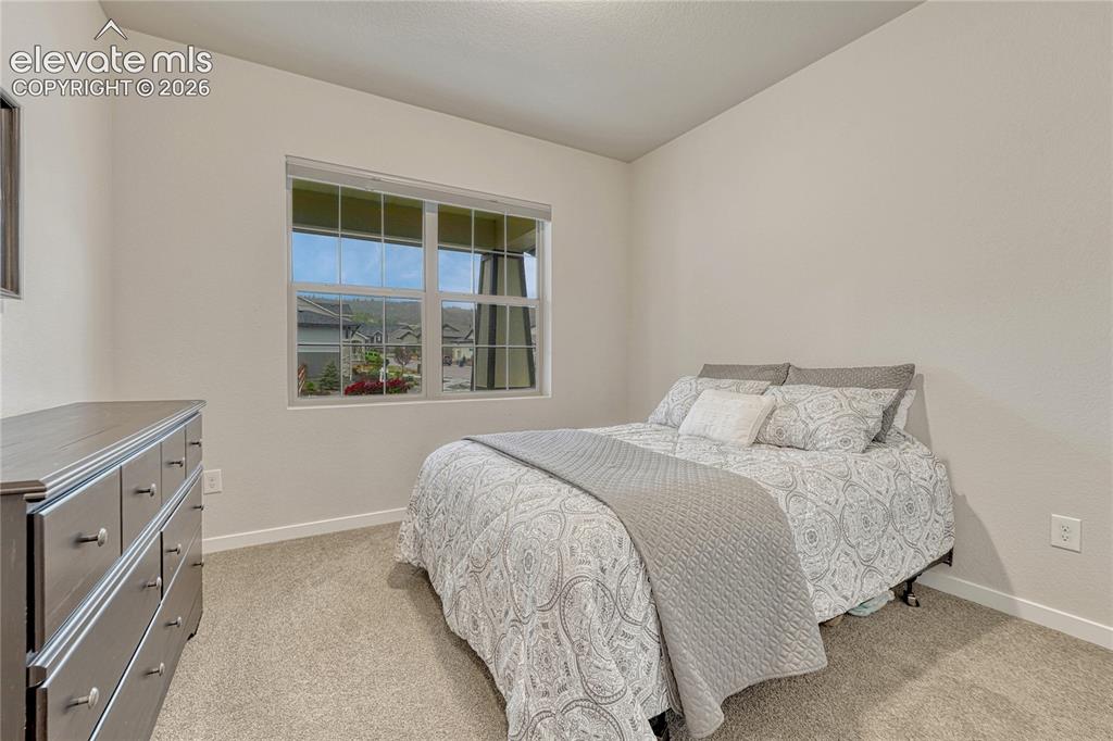 Image 24 of 41: Second main level bedroom with Front Range views. 