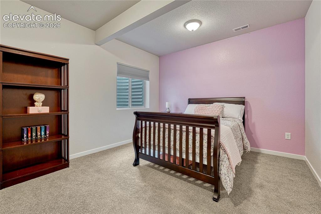 Image 32 of 41: First of two basement bedrooms...