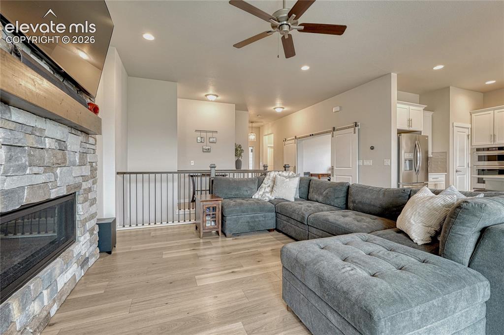 Image 7 of 41: Great room with stone gas fireplace...