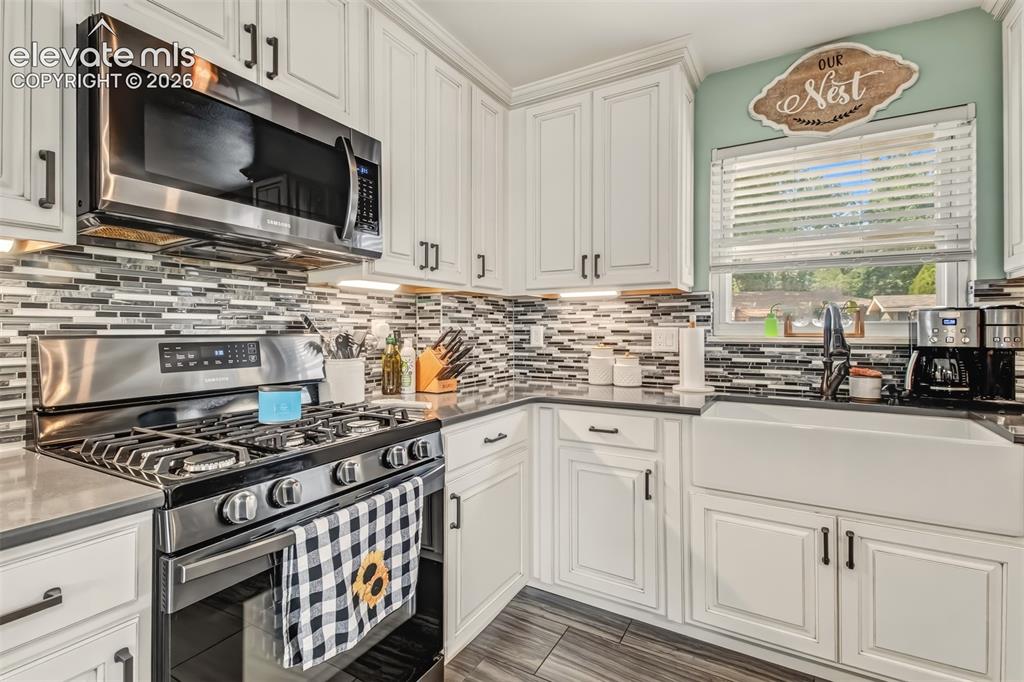 Image 6 of 31: Beautiful Remodeled Kitchen with Farm Style Sink and Gas Range