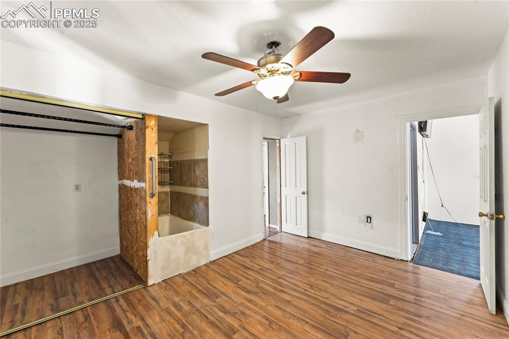 Image 13 of 36: Unfurnished bedroom featuring baseboards, a ceiling fan, and wood finished 