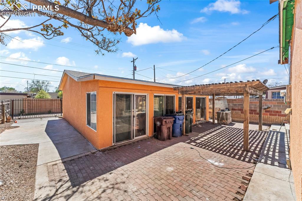 Image 27 of 36: Back of property with a fenced backyard, a patio area, stucco siding, and a