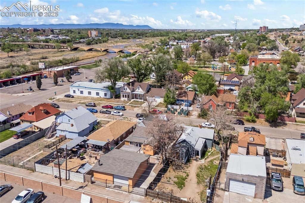 Image 34 of 36: Birds eye view of property with a mountain view and a residential view