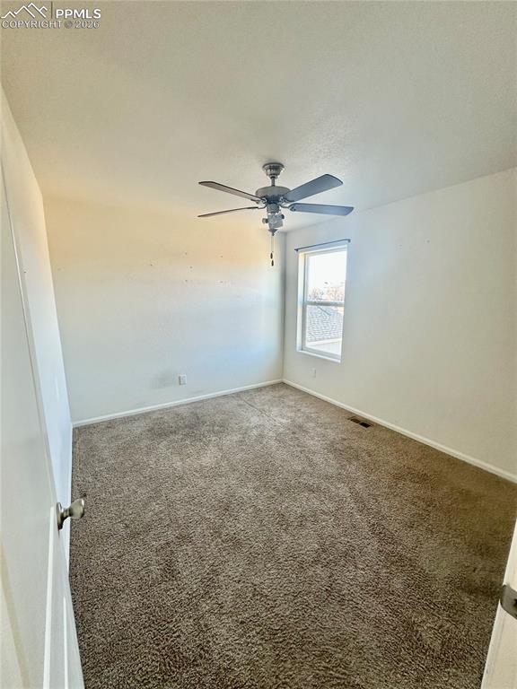 Image 16 of 17: Carpeted spare room featuring baseboards and a ceiling fan