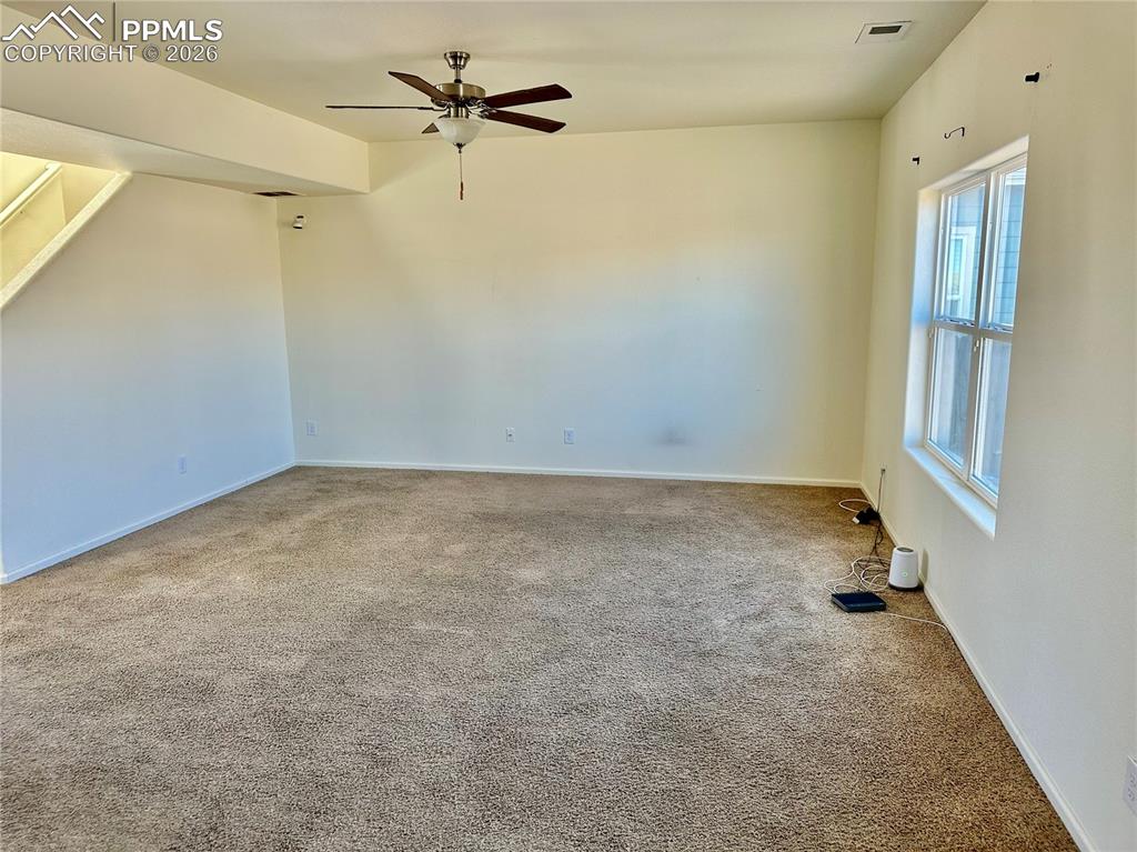 Image 3 of 17: Carpeted spare room featuring ceiling fan and baseboards