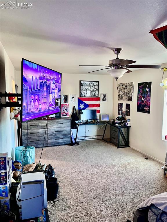 Image 9 of 17: Carpeted living room featuring an office area and ceiling fan