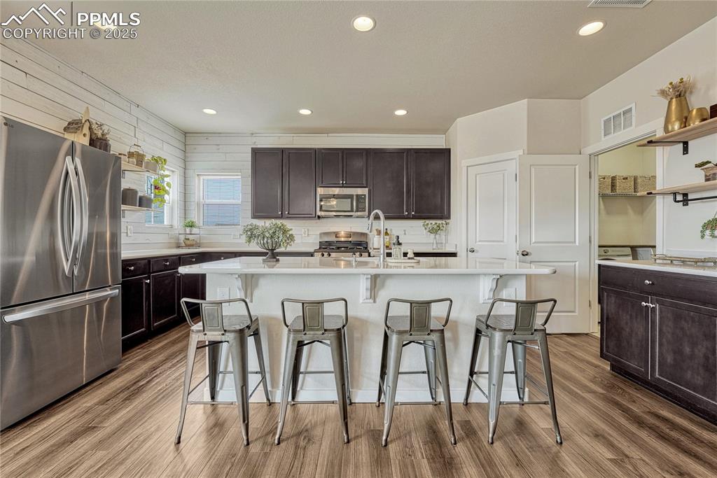 Image 16 of 50: Kitchen with recessed lighting, shiplap, espresso cabinets