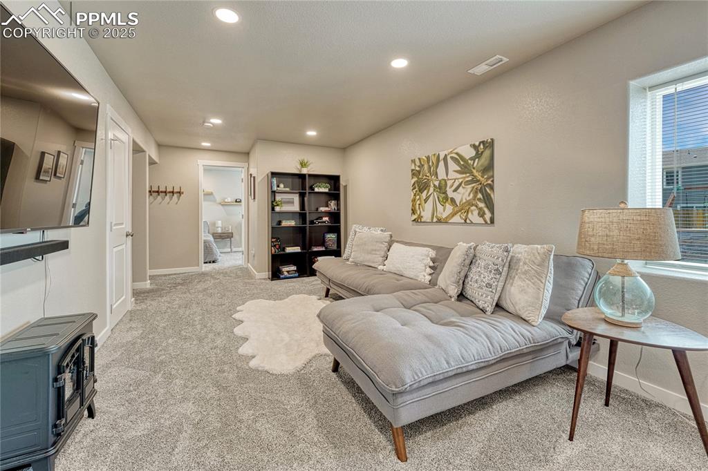 Image 32 of 50: Rec room/family room in basement with recessed lighting