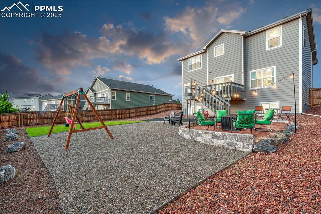 Image 45 of 50: Xeriscaped backyard with patio for a fire pit area