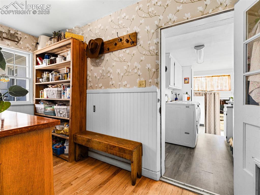 Image 15 of 50: Butlers pantry through the archway of kitchen. Tall wall shelving stays