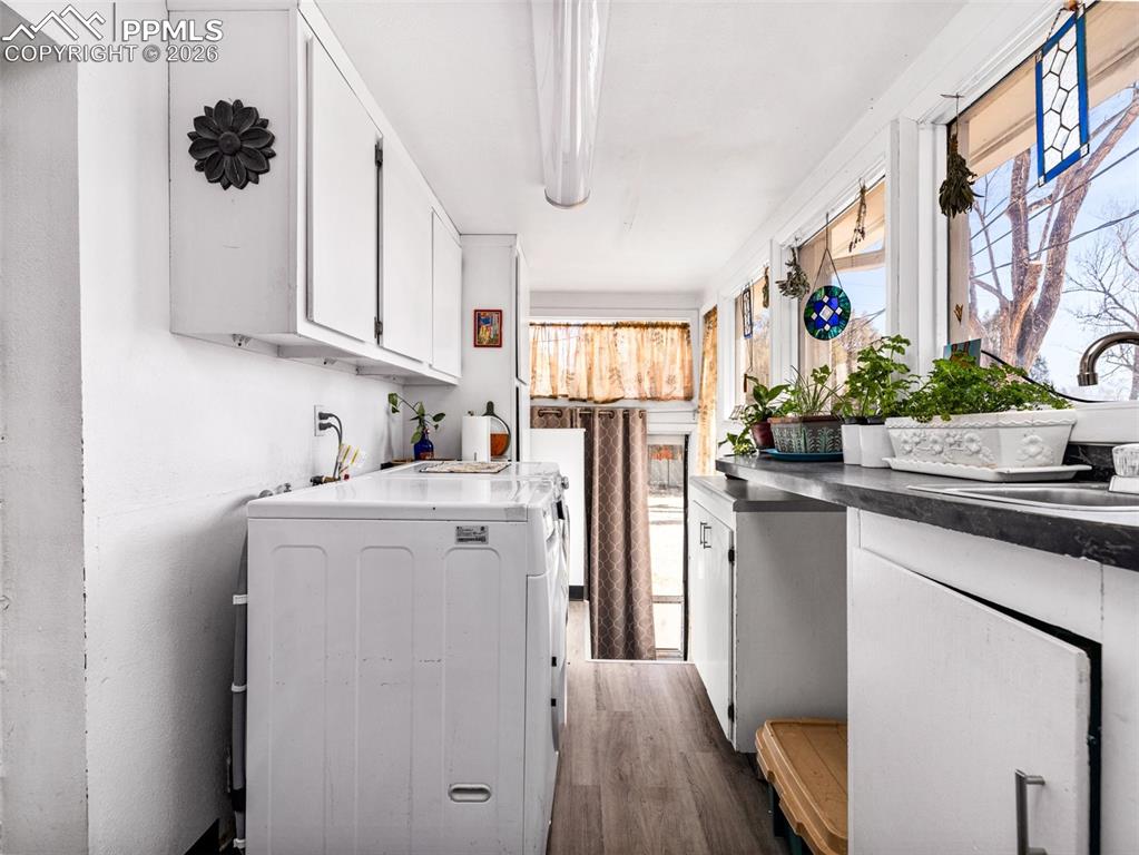 Image 17 of 50: The laundry space is off the garage and the kitchen with laminate flooring