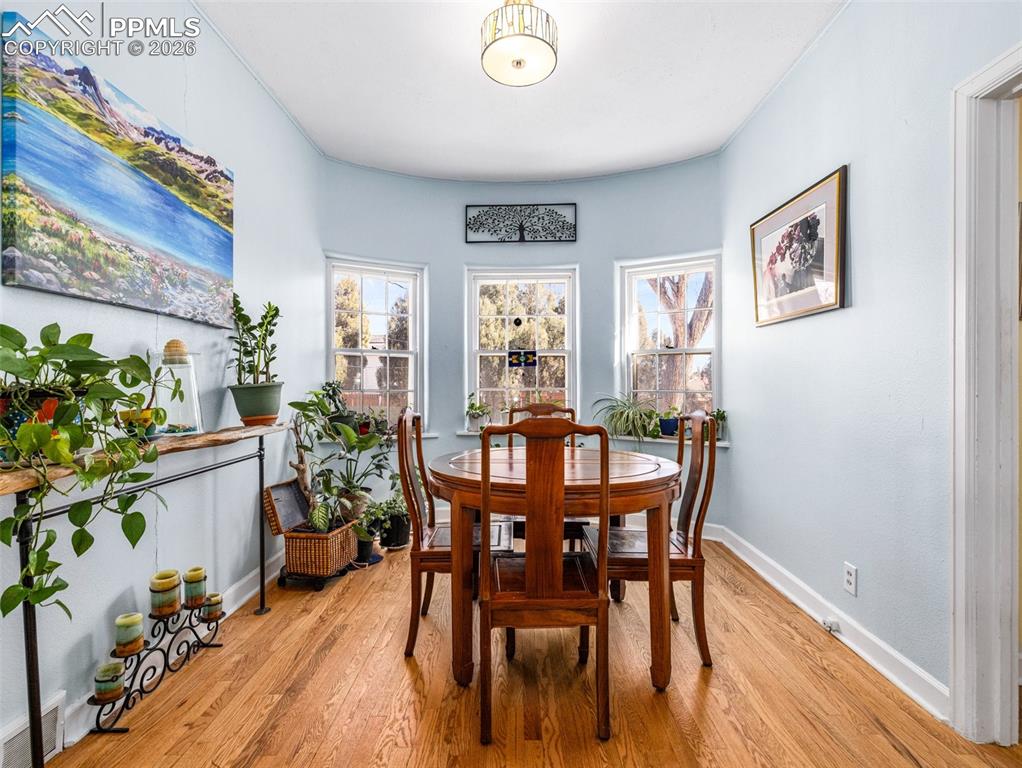 Image 18 of 50: So much sun light! This breakfast nook can double as a plant room.
