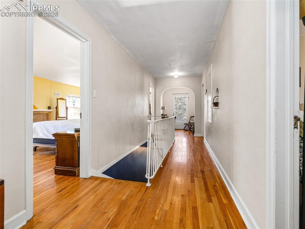 Image 31 of 50: This catwalk hallway leads to 3 bedrooms and a full bath plus a Juliet balc