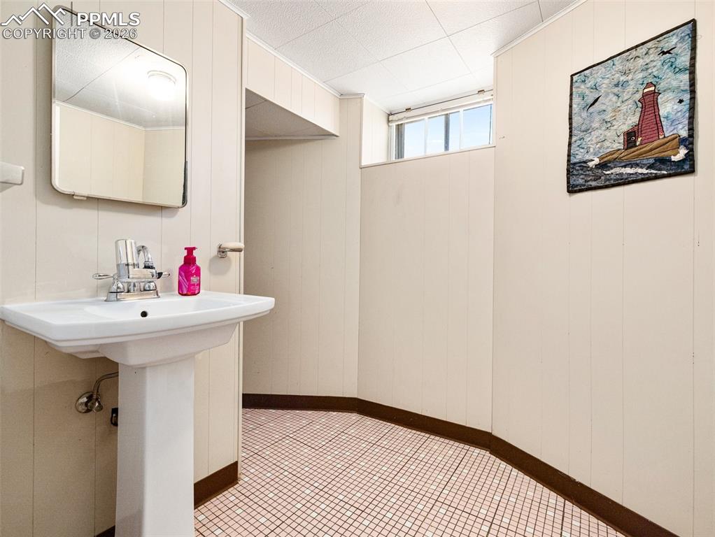 Image 40 of 50: Half bath serves the basement