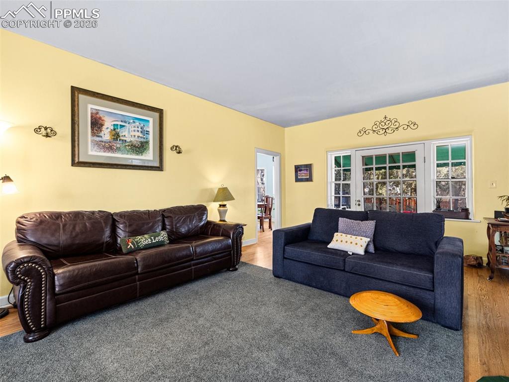 Image 6 of 50: Access to the backyard through this door to the covered back patio and thro