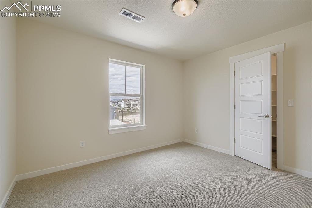 Image 19 of 28: Spare room featuring light colored carpet and baseboards