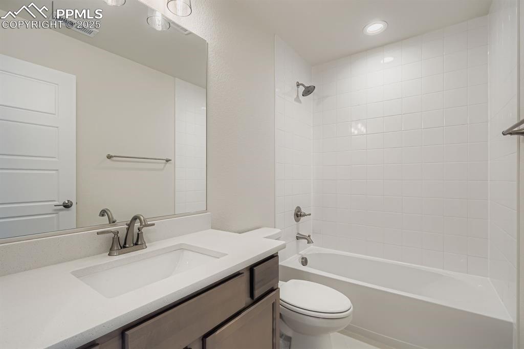 Image 20 of 28: Bathroom with  shower combination, vanity, and recessed lighting