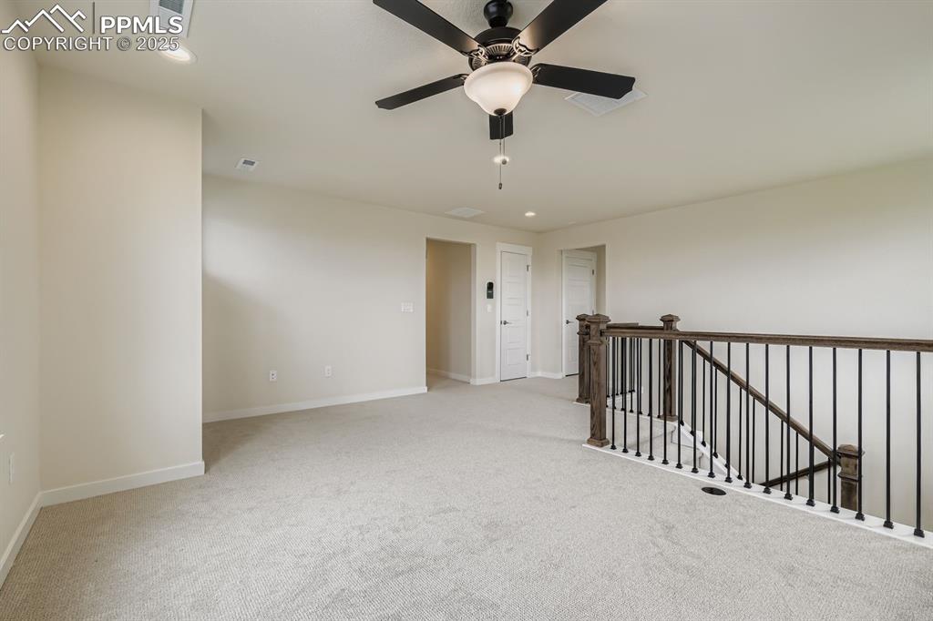 Image 21 of 28: Spare room featuring recessed lighting and light carpet