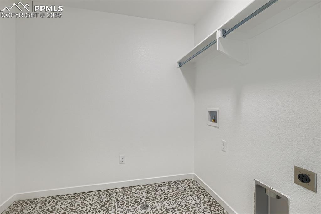 Image 22 of 28: Washroom with baseboards and washer hookup