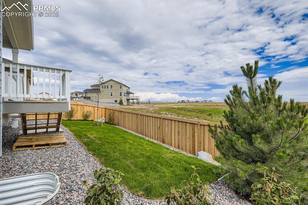 Image 27 of 28: View of fenced backyard