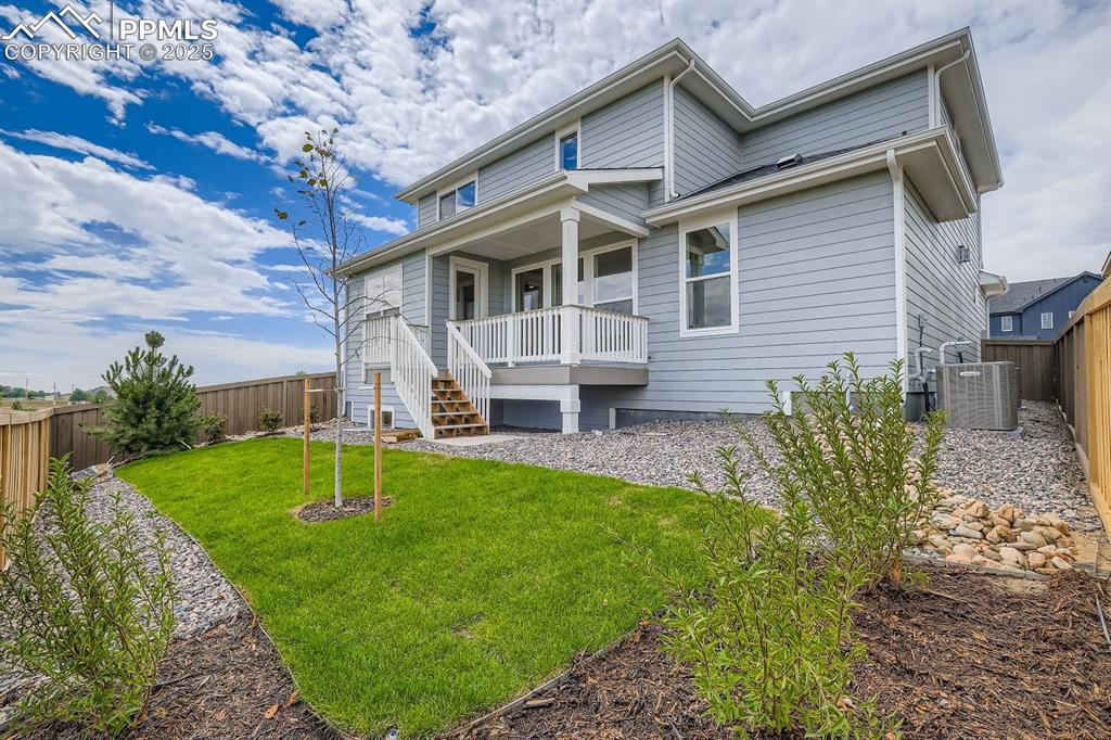 Image 28 of 28: Rear view of property featuring a fenced backyard and stairway