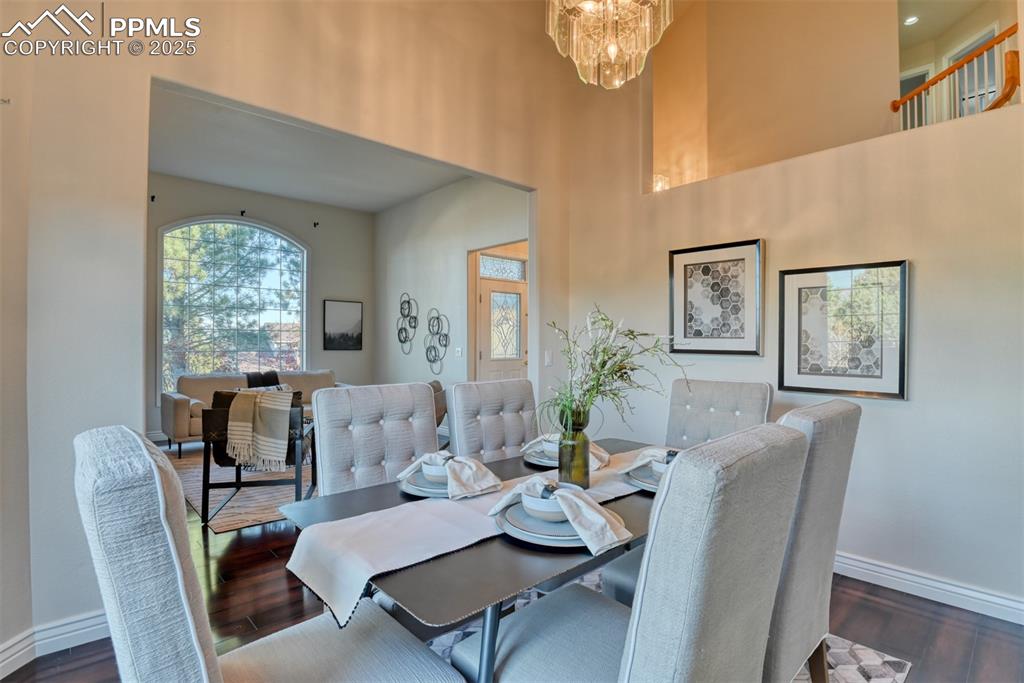 Image 11 of 44: Dining space featuring dark wood-type flooring and a chandelier