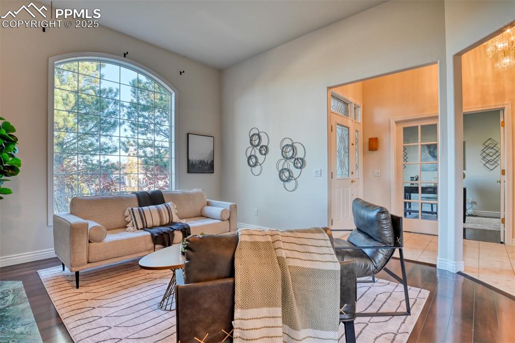 Image 21 of 44: Living area featuring dark wood-style floors and baseboards